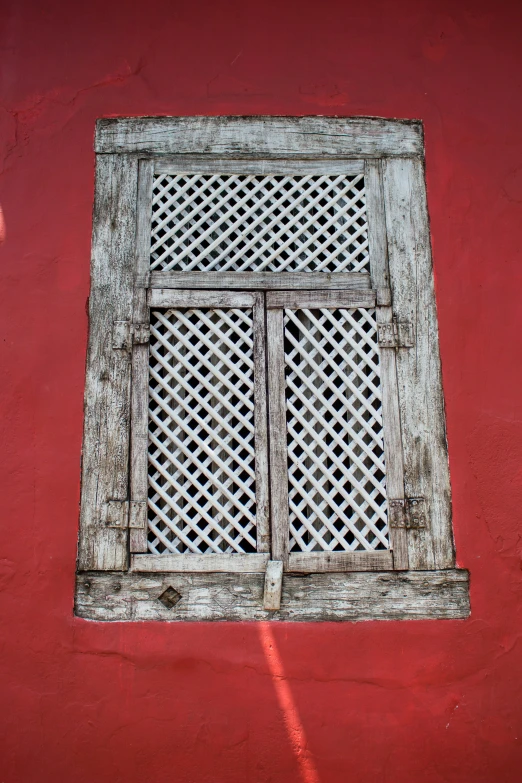 the window is closed and it is a red wall