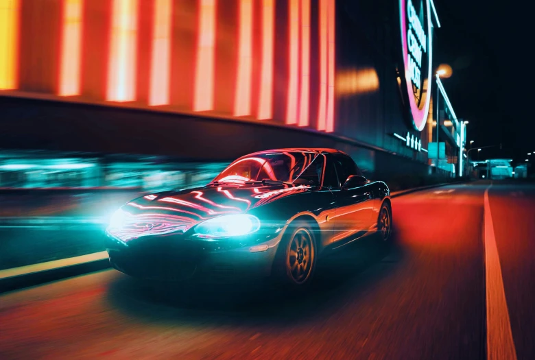 a red and black car driving down the road