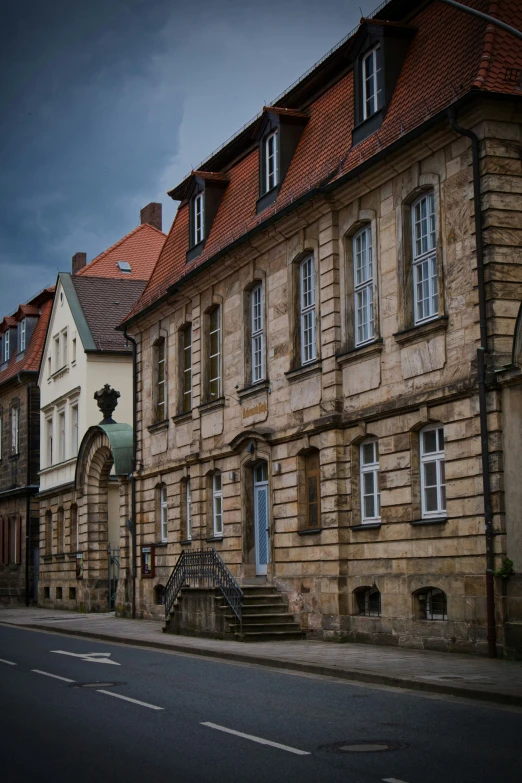 an old stone building on the side of the street