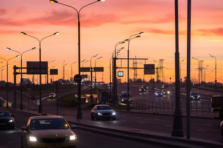 multiple lanes of traffic on a highway at sunset