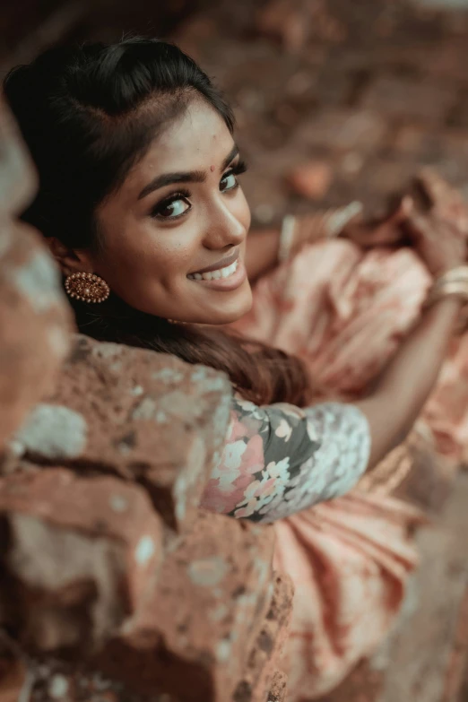 a woman smiling looking up with her arms crossed