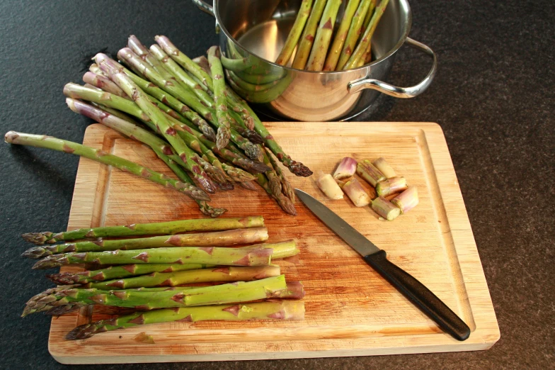 a  board with asparagus, ginger and garlic