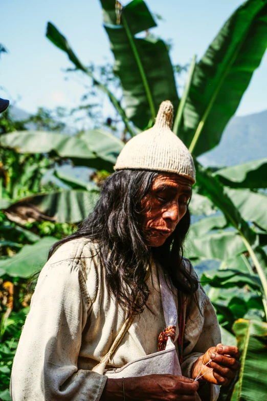 a person with long hair and a white hat