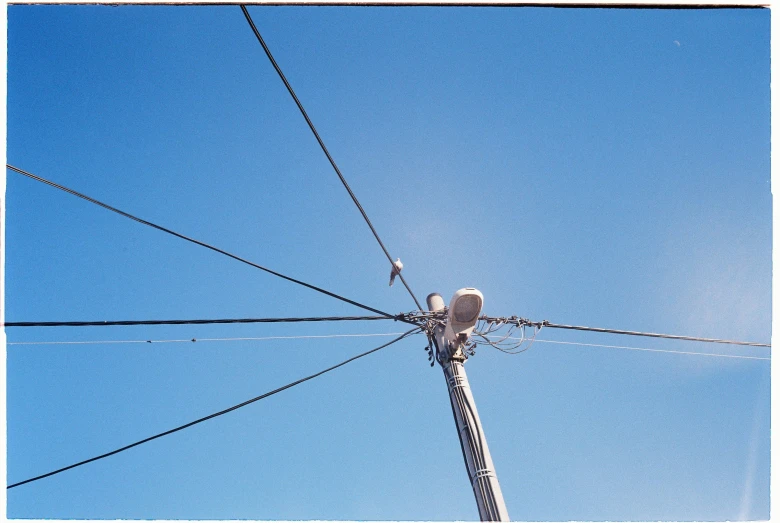the electrical wire is very tight on a bright blue sky