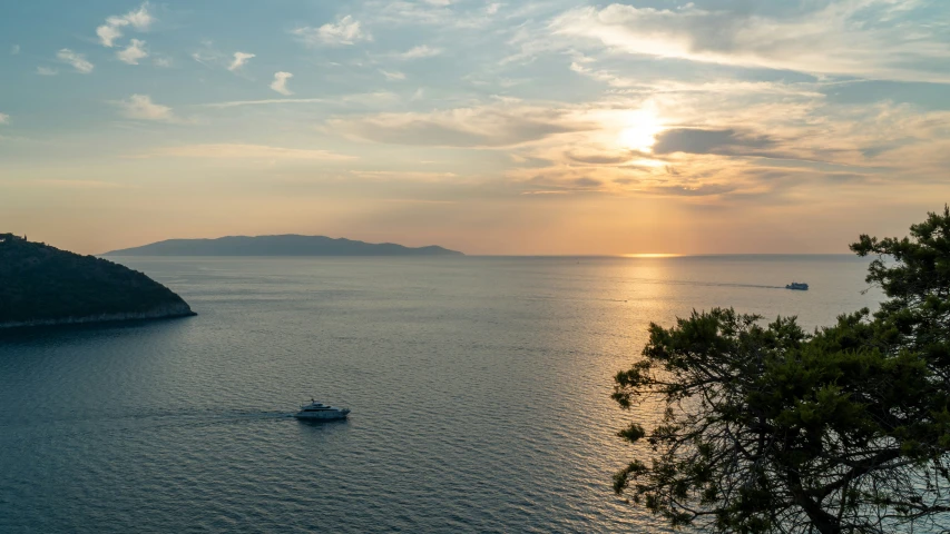 a boat in a body of water at sunset