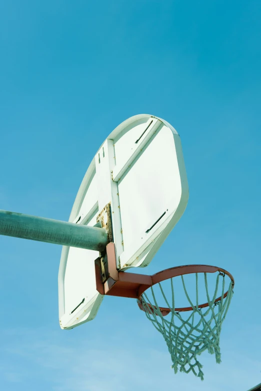 a basketball going into the basket on a clear day