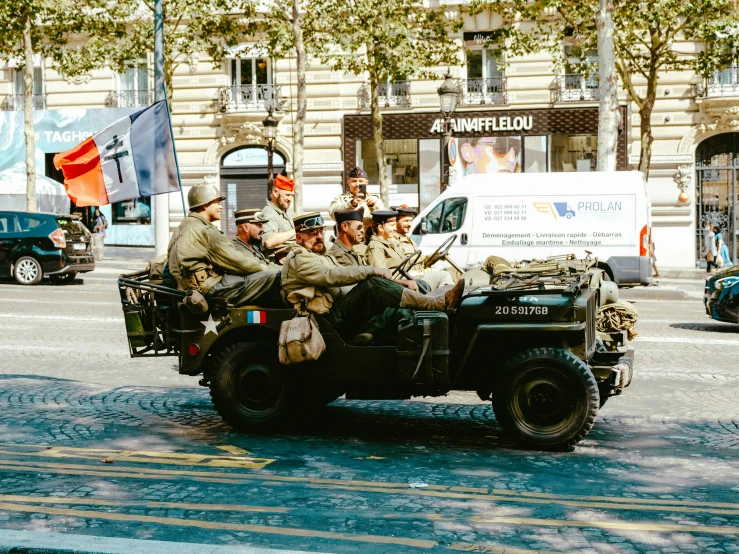 a military vehicle with a number of soldiers riding it