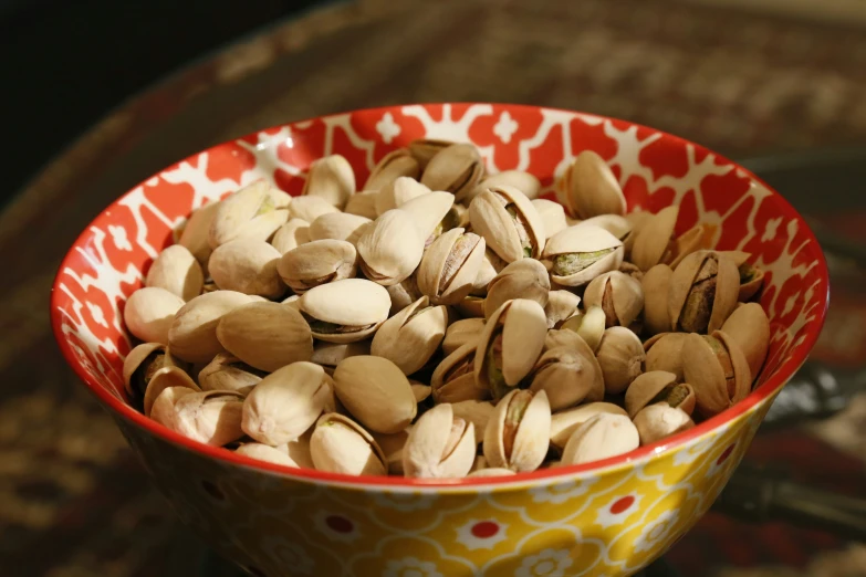 a bowl filled with nuts next to a table
