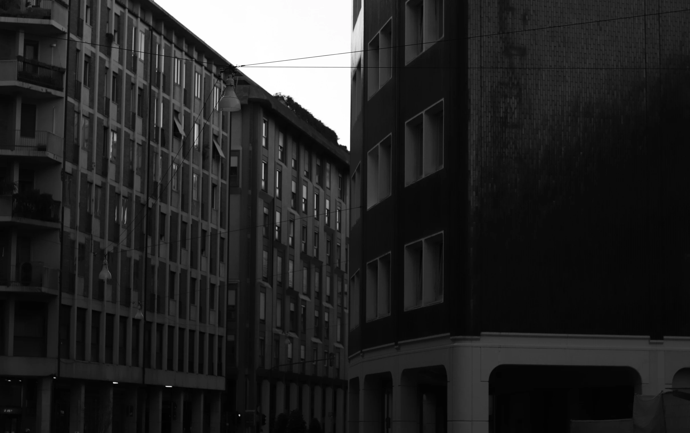 people standing on the windows of an apartment building