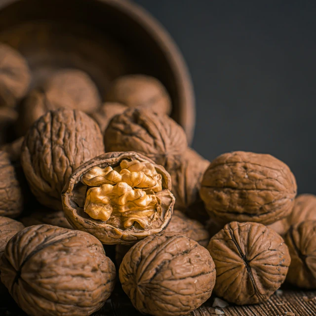 a bag of walnuts sitting next to a pile of nuts