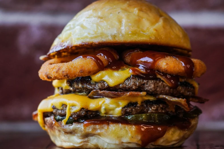 a hamburger that has melted cheese and other things on it