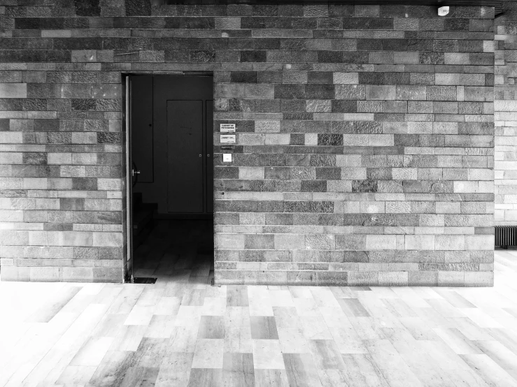 a black and white po of a wall with an open doorway