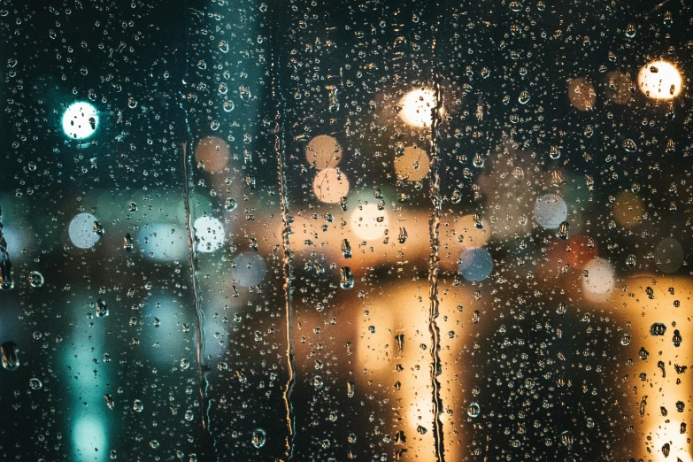 a blurry s of rain and traffic through a window