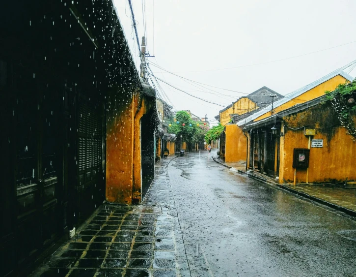 the wet street and buildings are all yellow