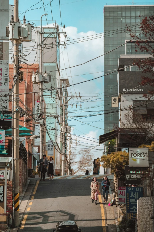 a couple of people that are walking down a street