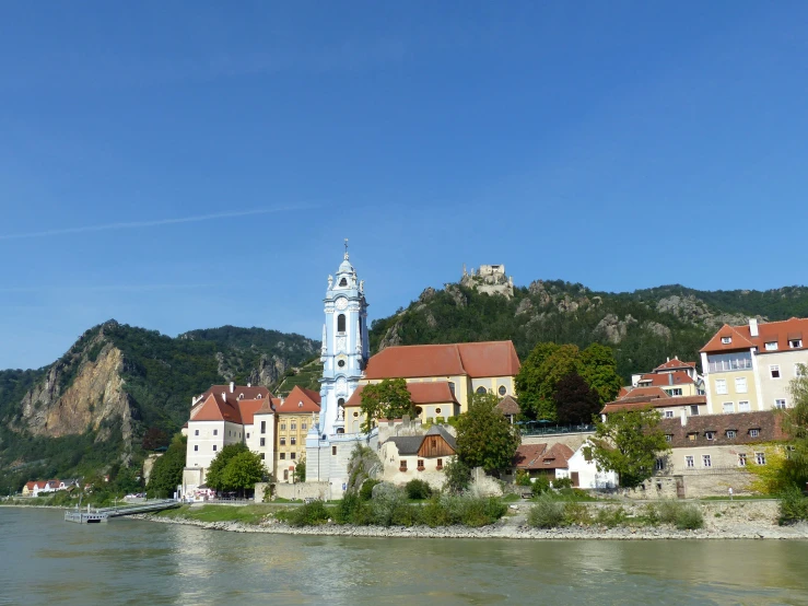 an old castle sits next to some water