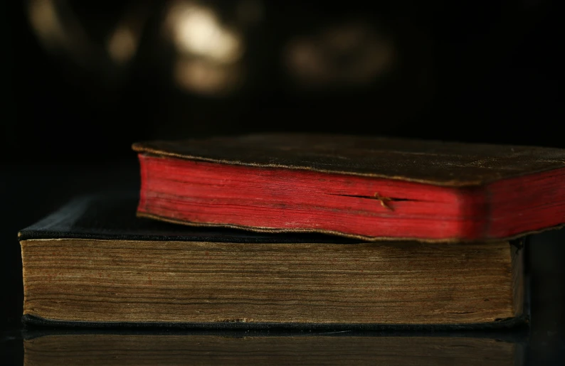 an old book that is opened sitting on a table