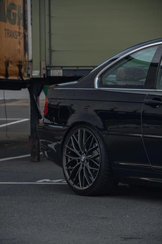 a black bmw in parking spaces and on its tires