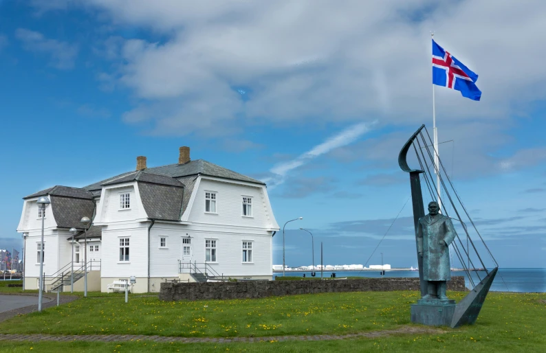 the white building has a flag flying on it