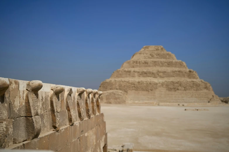 a brown wall sitting next to a pyramid