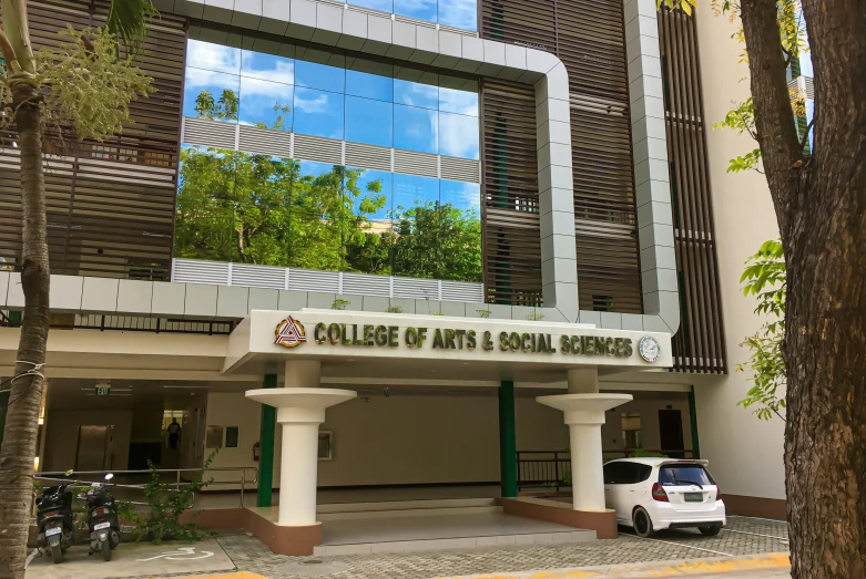 a building with white pillars is reflected in the glass window