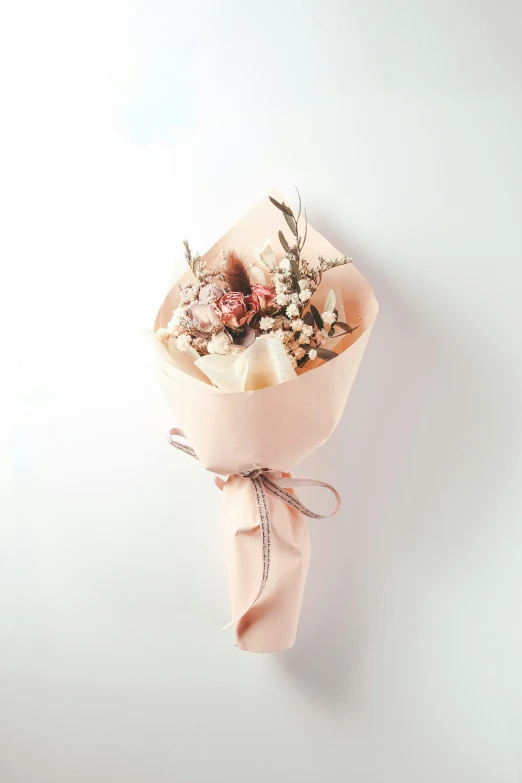 a wrapped flower bouquet laying on the table