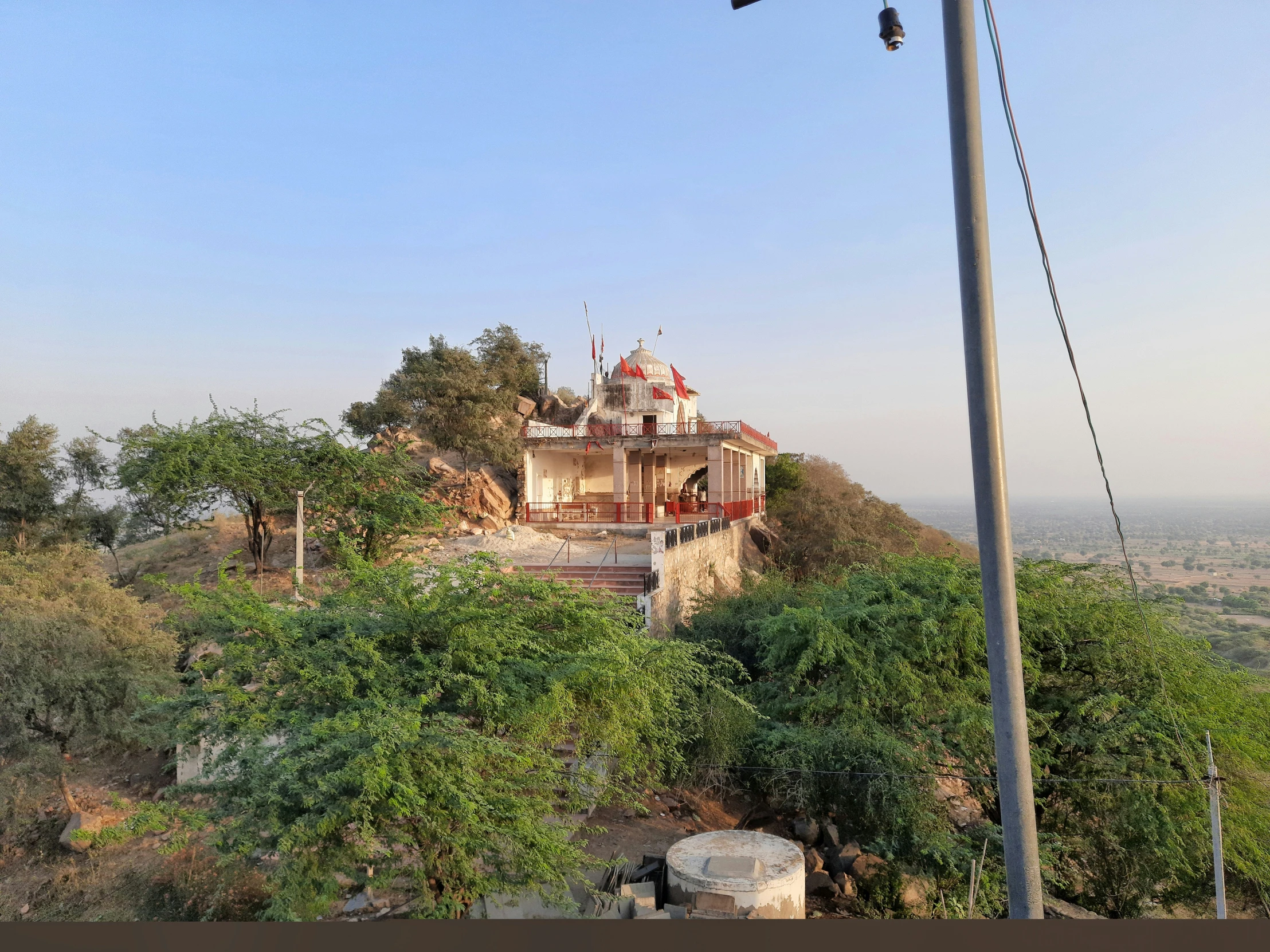 the church sits on top of a hill surrounded by trees