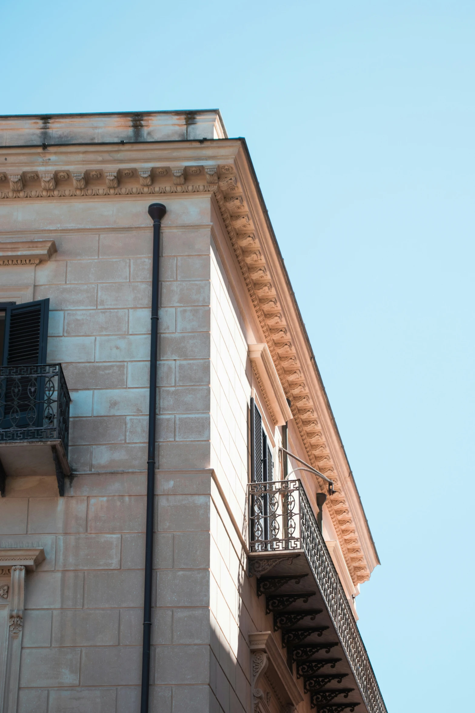 a building with iron balconies and a balcony