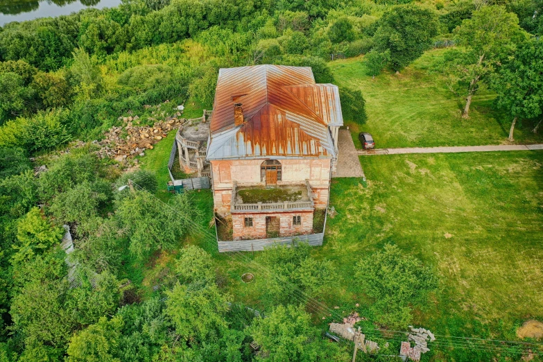 a rusty building in the middle of a forest