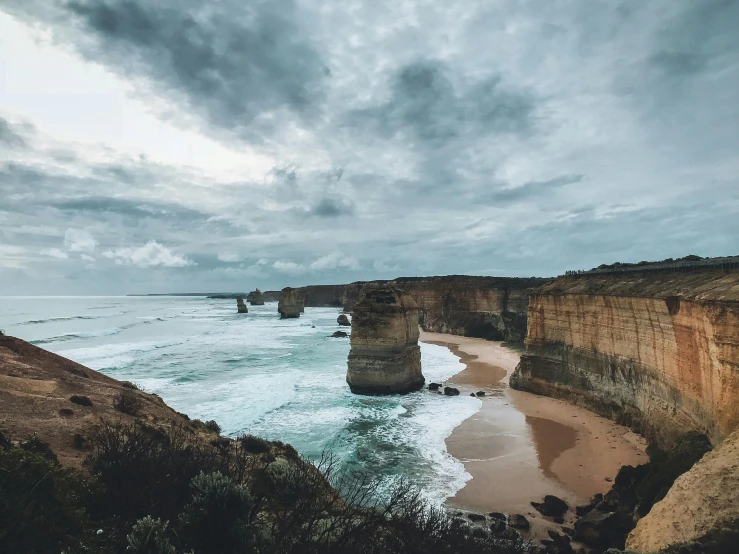 a picture of the beach next to some rocks