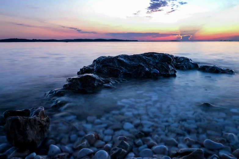 rocks in the middle of a body of water