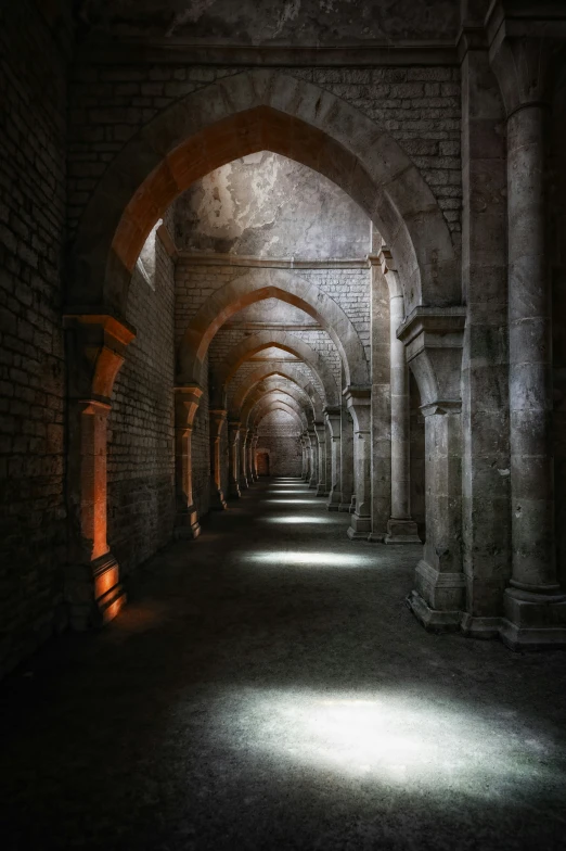 an empty stone tunnel with many arches