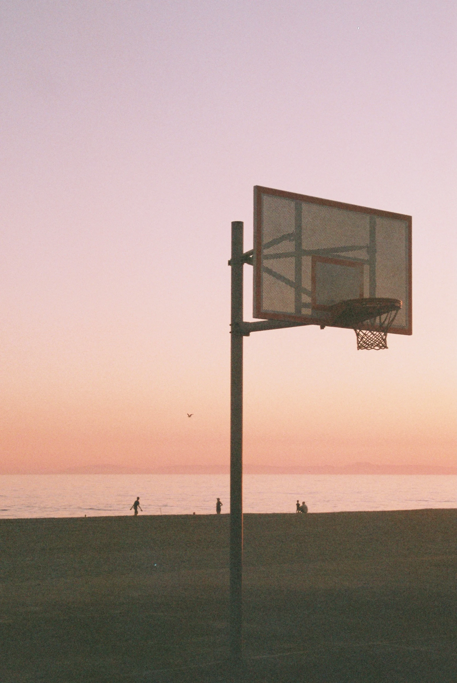 the basketball hoop is in front of an ocean