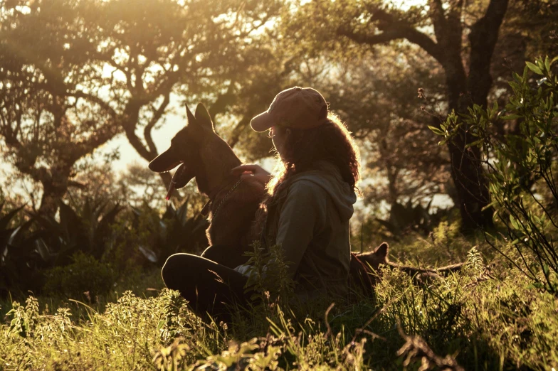 the dog and its master are sitting in the tall grass