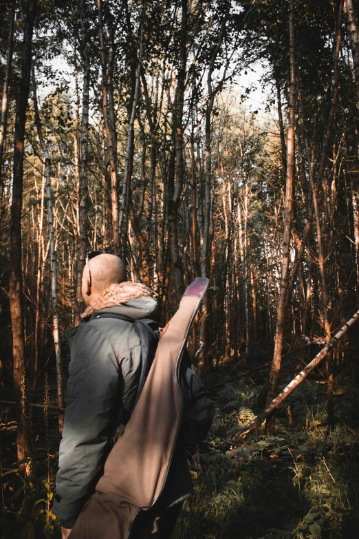 the woman is hiking in the woods carrying a backpack