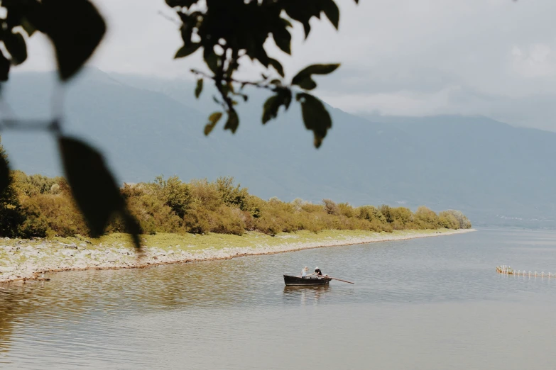 a group of people riding on a boat on a lake