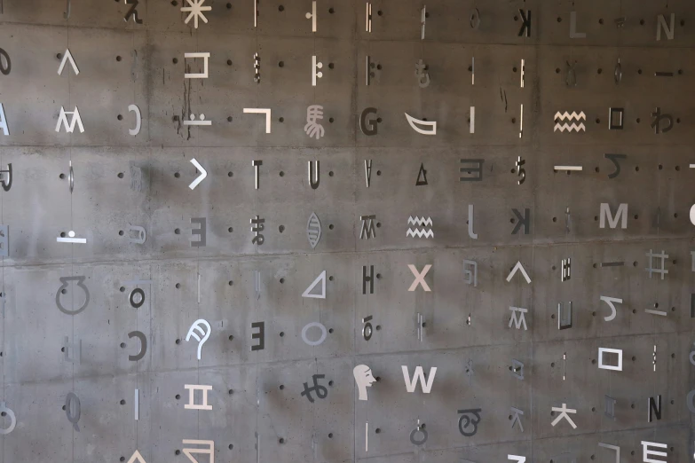 a large concrete wall covered in multiple types of letters