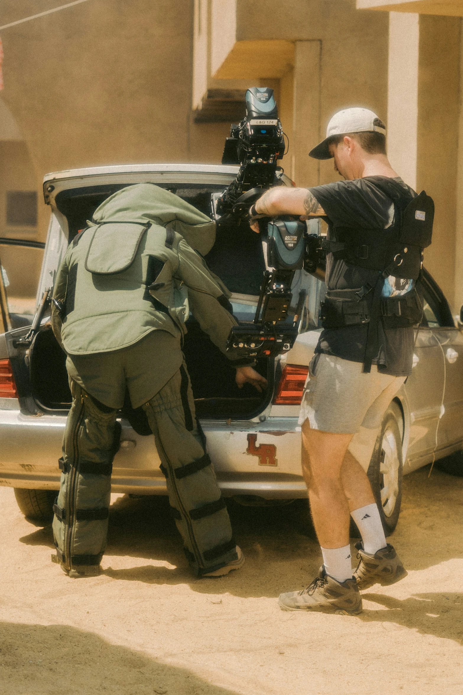 a couple of men near a car getting soing on