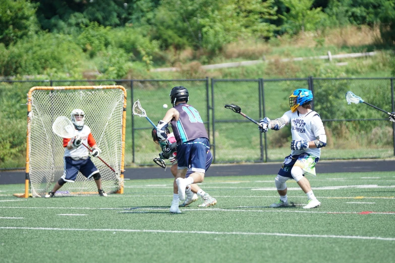 a couple of people are playing a game of lacrosse