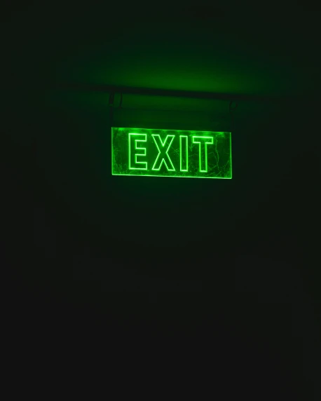 the exit sign is green in the dark