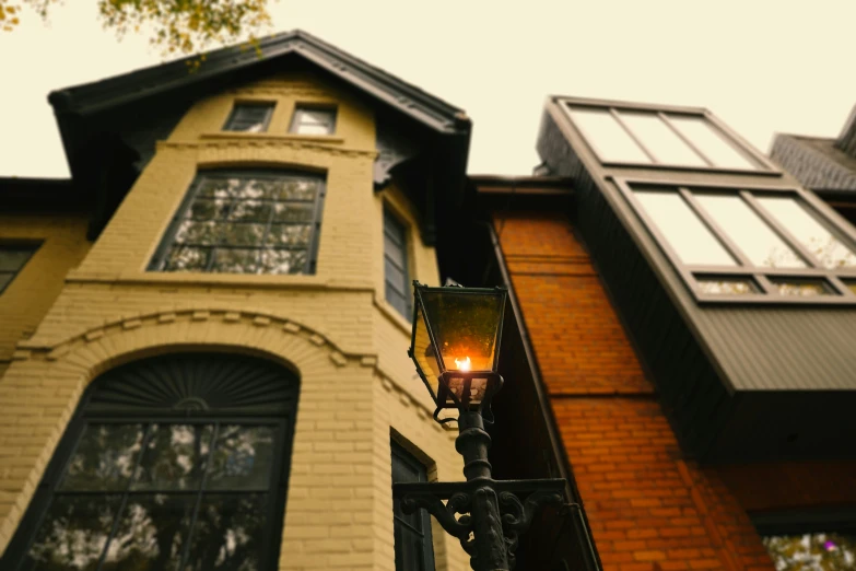 a house with a large window and a lamp in the front