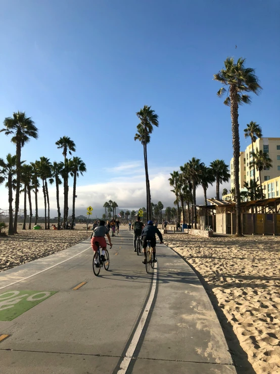 many bikers are riding down the street together