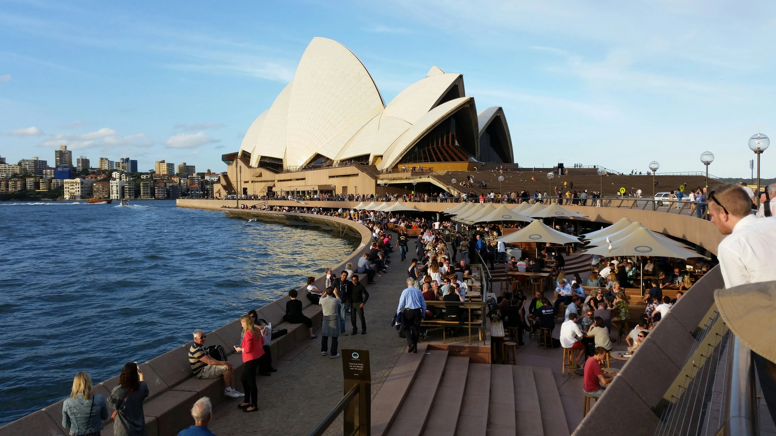 people walking up and down the stairs in front of the opera