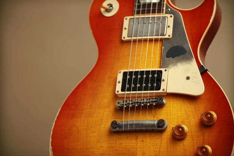 an electric guitar sits upright on display