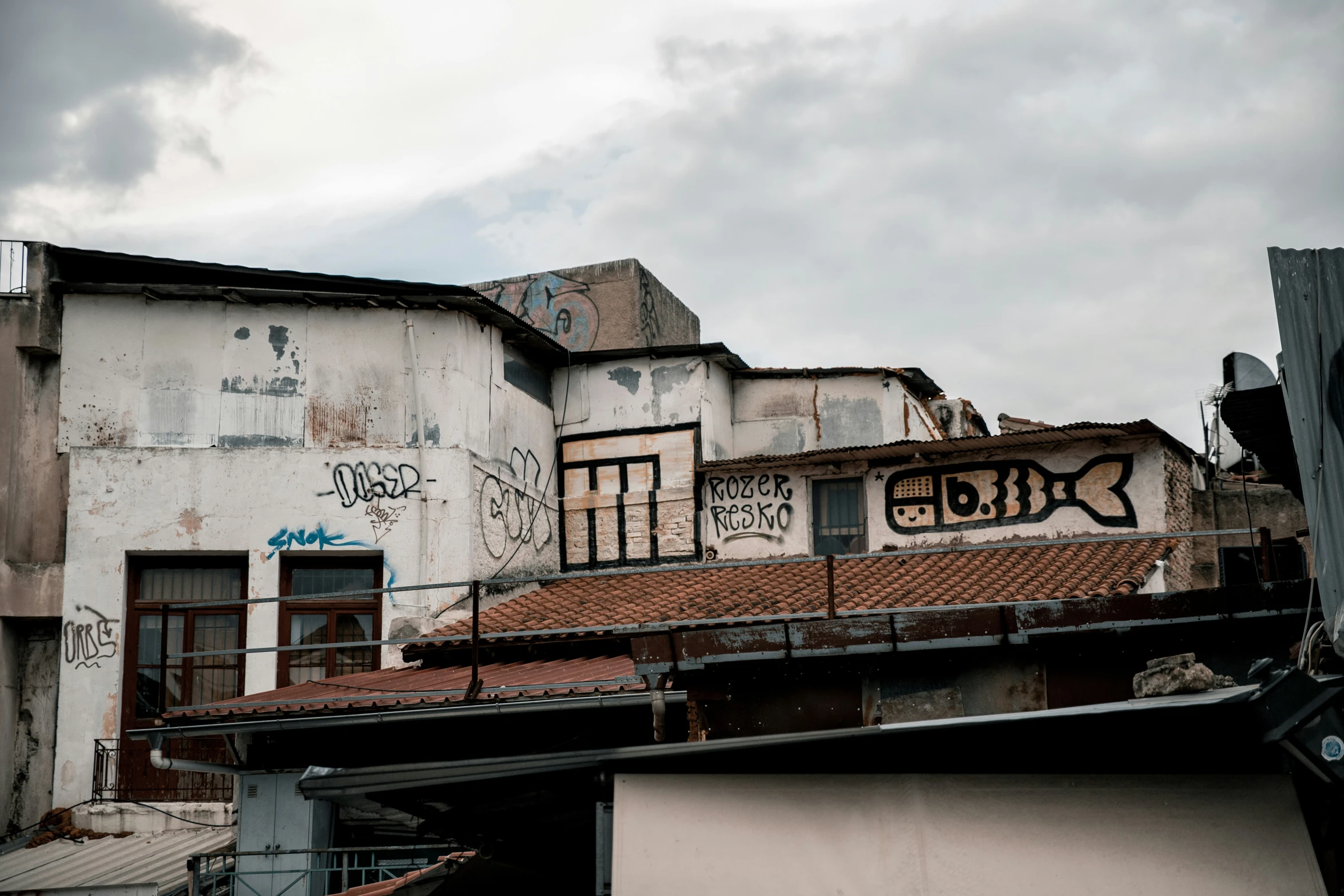 old city buildings with graffiti on the roofs