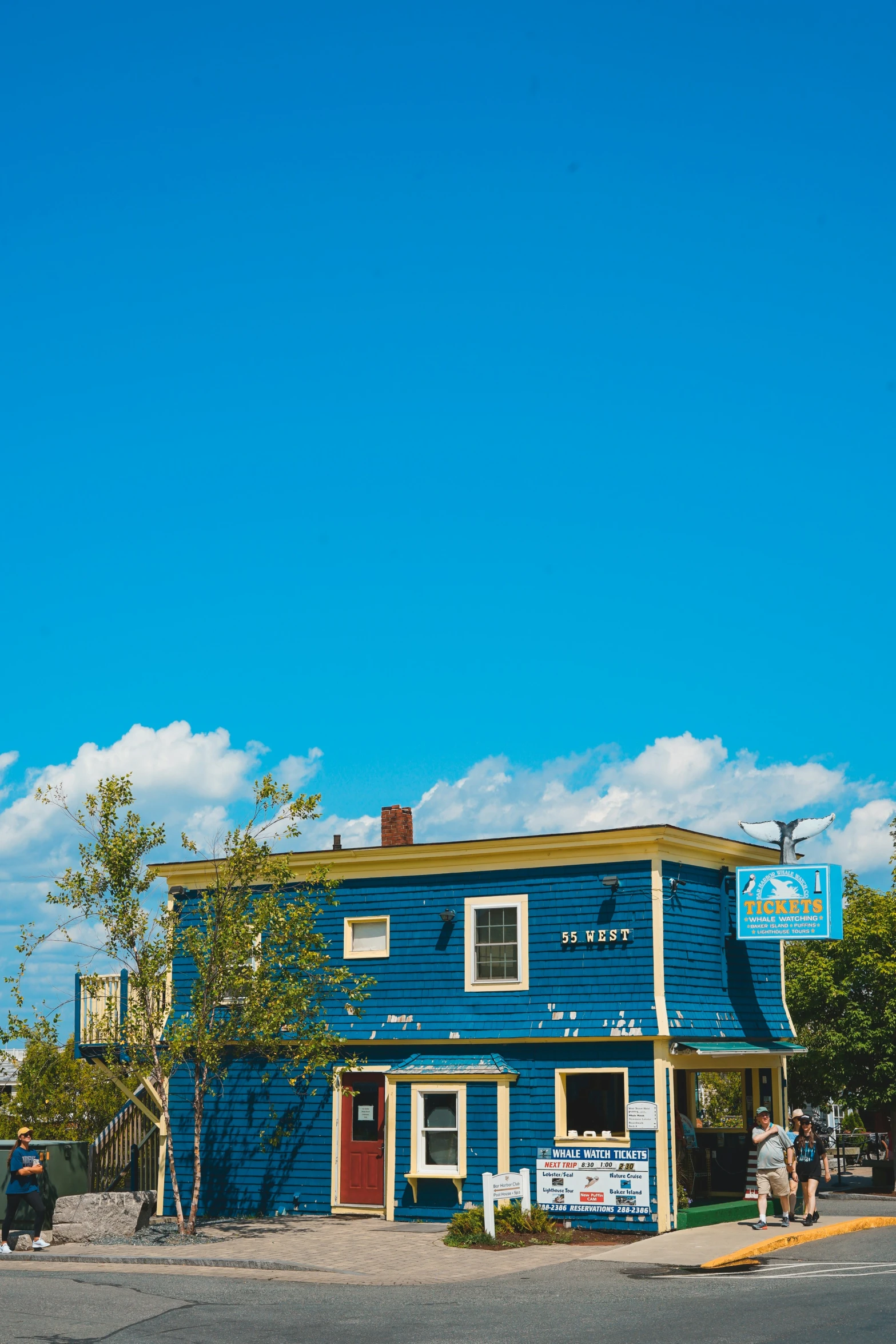 a blue building with a stop sign in the corner of it