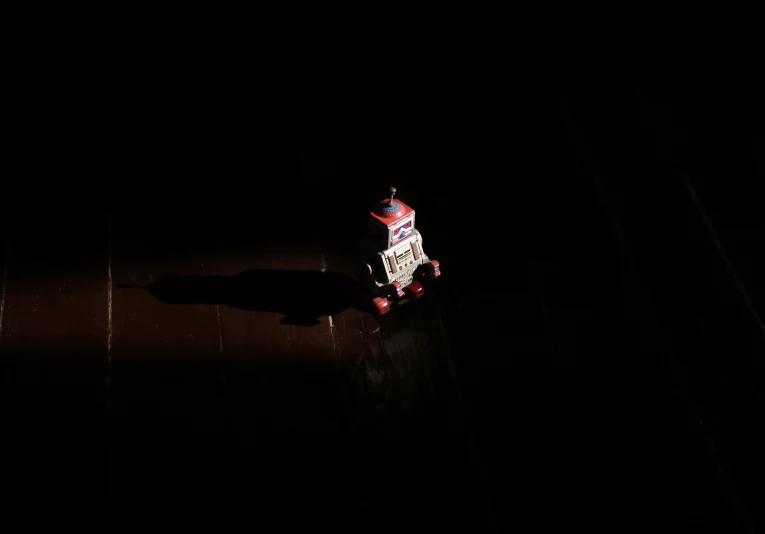 a skateboarder riding through the dark on his board