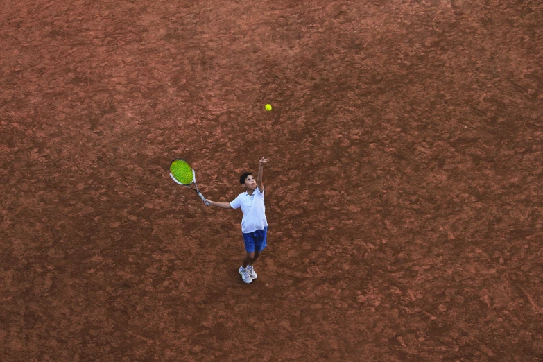 a person on a court with a racket and ball