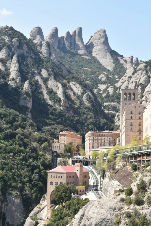 a mountain with a small train going down the track