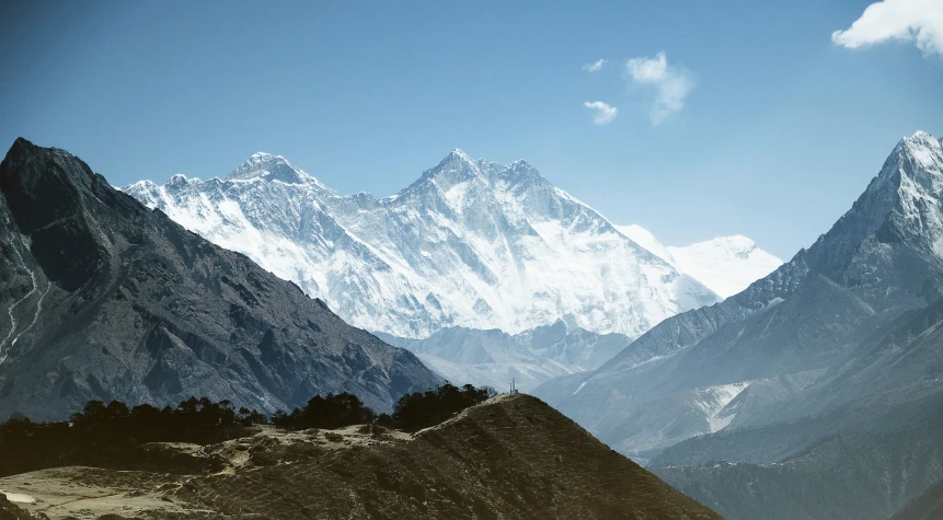 the snow capped mountains are clear with some clouds